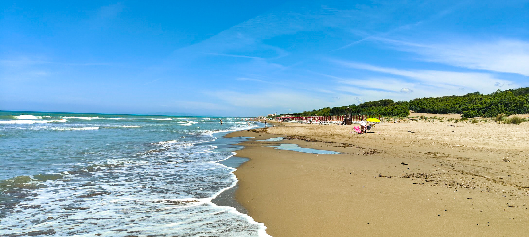 The wide stretch of sand beside the sea.